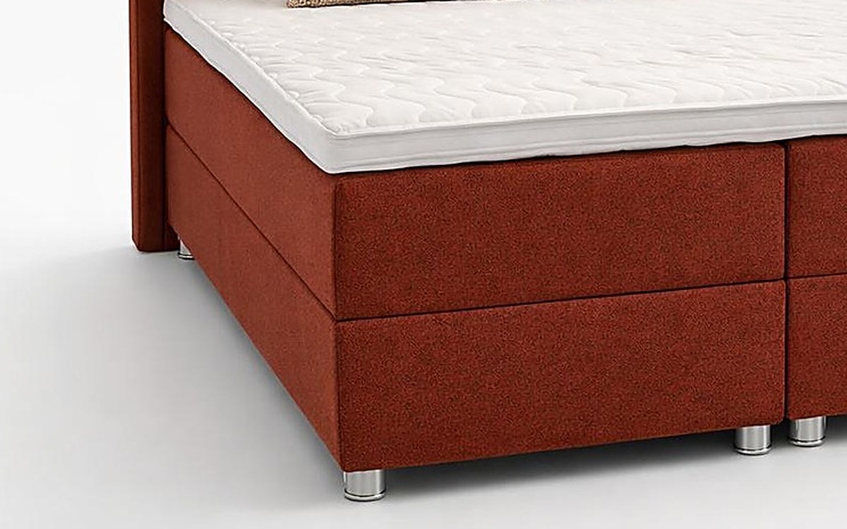The bed from the side: topper on top, the mattress in its fabric cover below, the storage box at the bottom